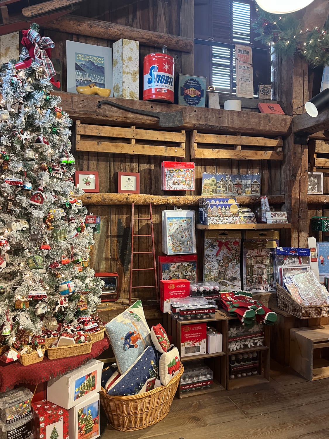 Inside the Plymouth Notch general store, its rough-timber walls stocked with a decorated tree and holiday goods.