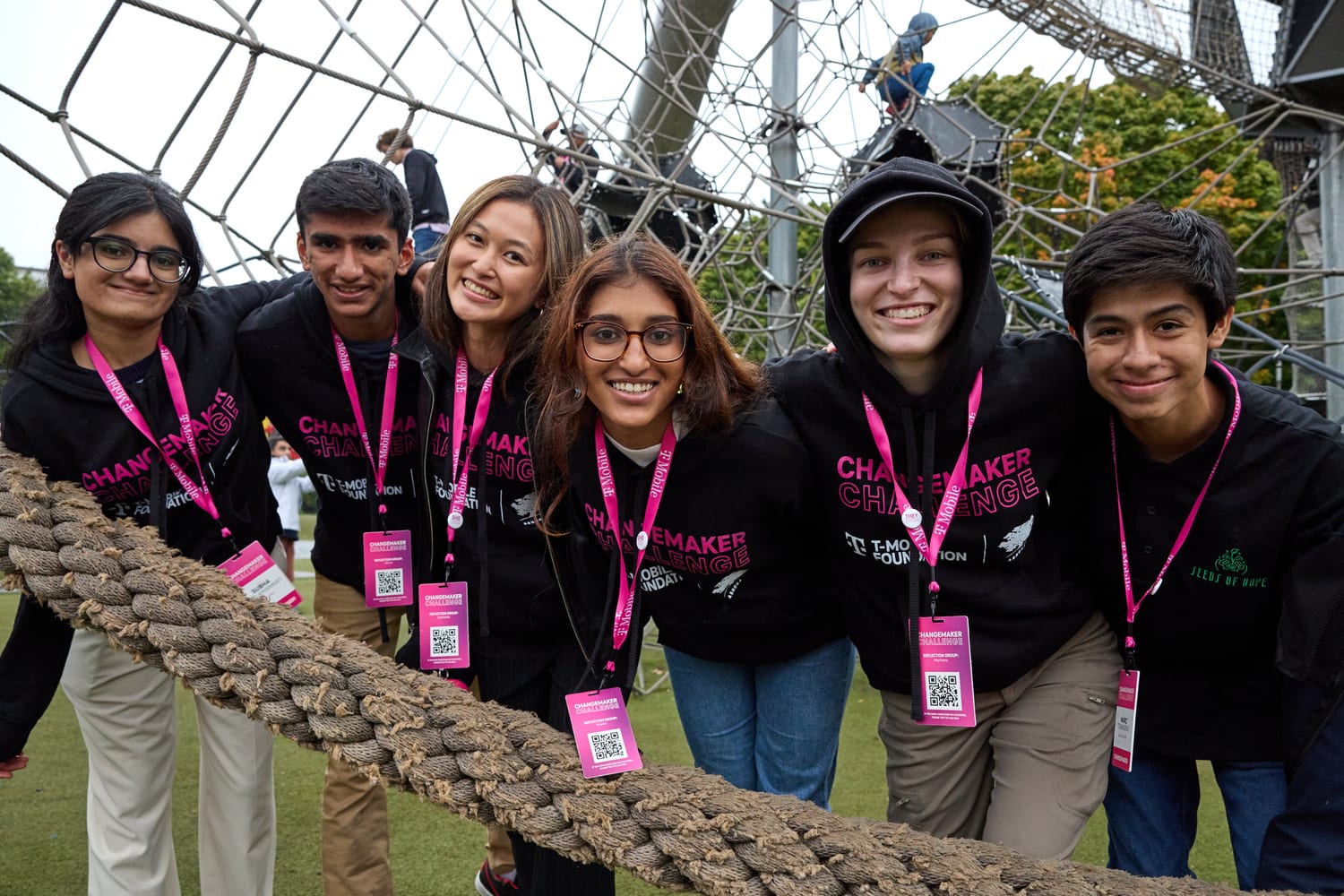 Ava and her reflection group posing at a rope-net structure.