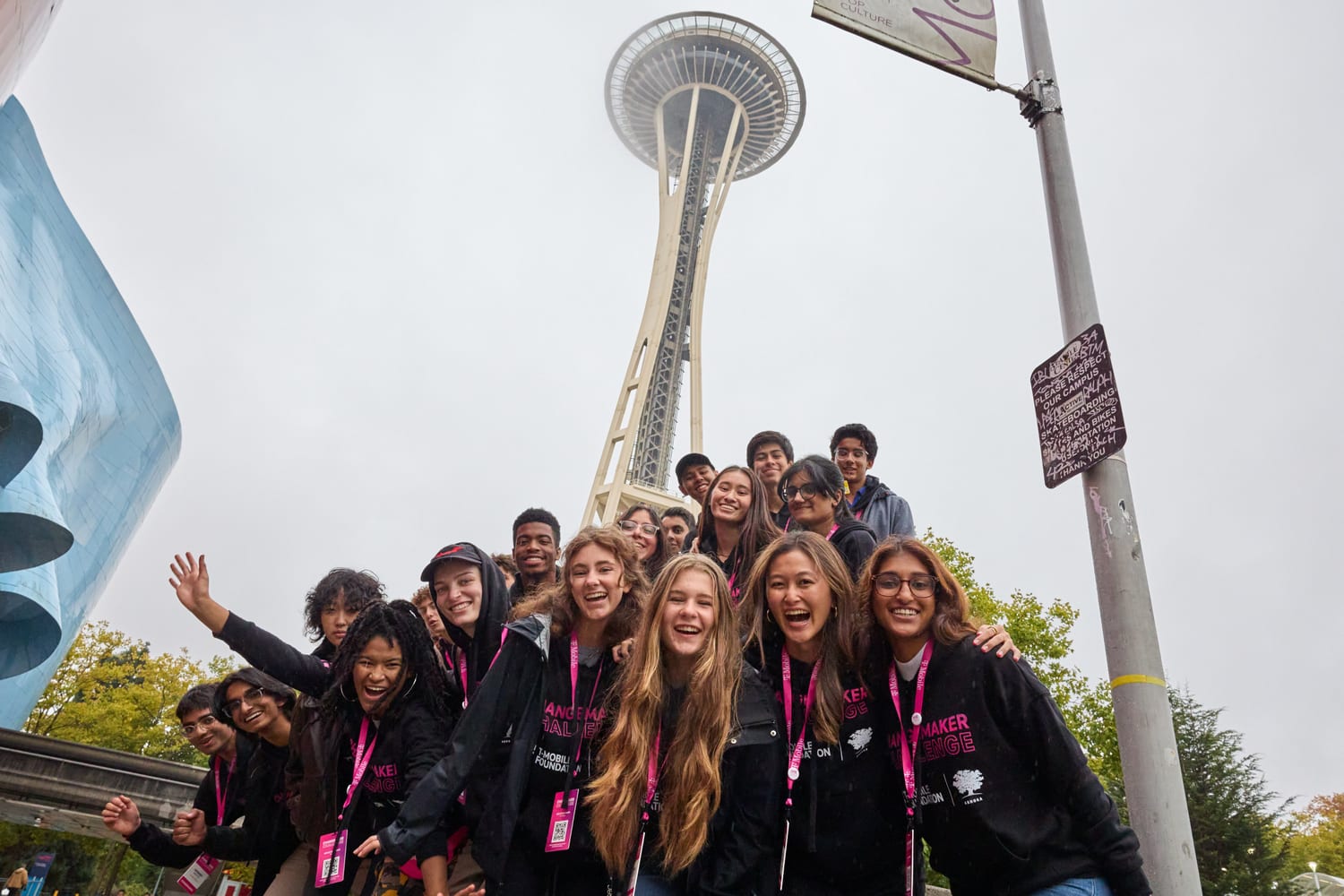 The cohort laughing together beneath the Space Needle.