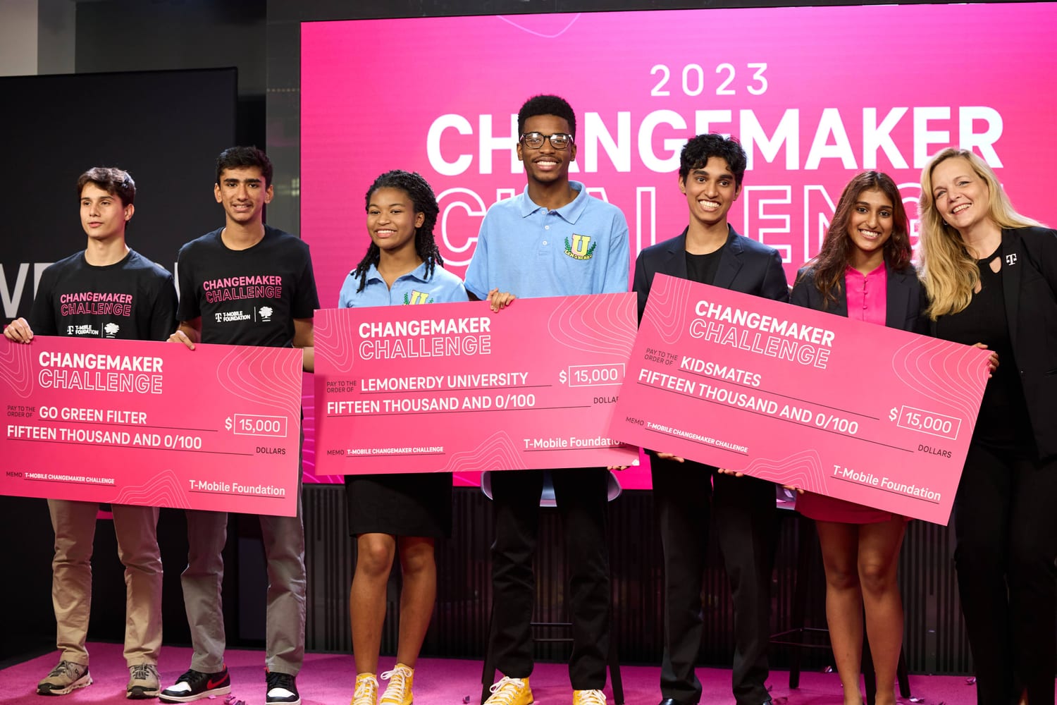 The three winning teams on stage, each holding a $15,000 T-Mobile Foundation check.