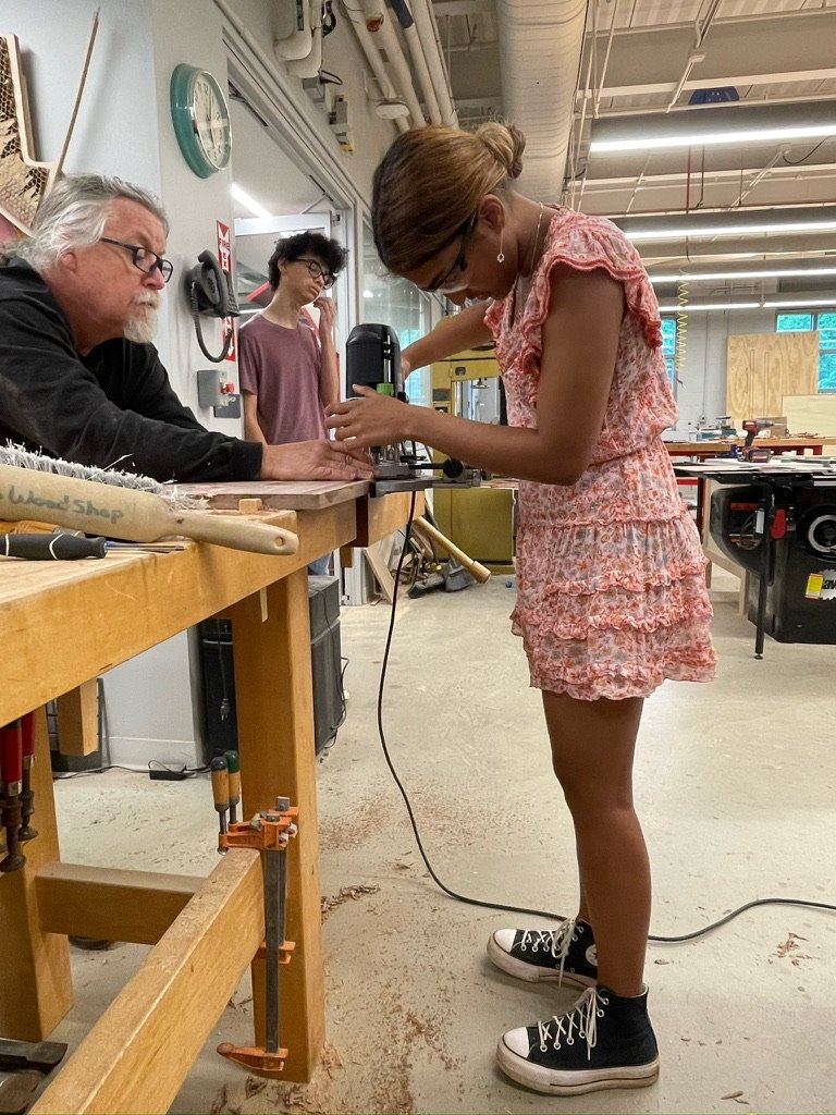 Ava at the drill press in the wood shop