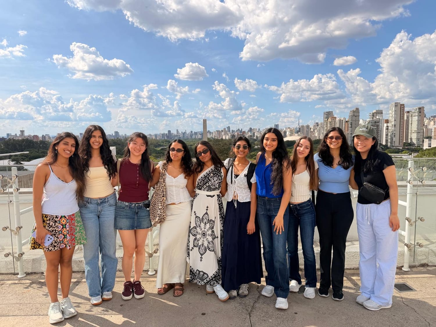 Ava and friends on a rooftop overlooking the São Paulo skyline