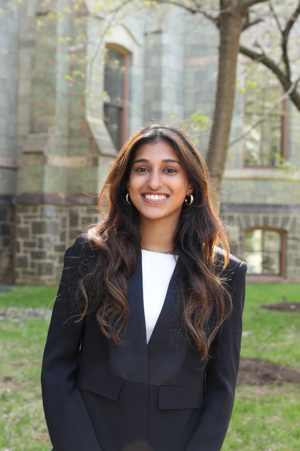Ava in a blazer for a professional headshot on campus