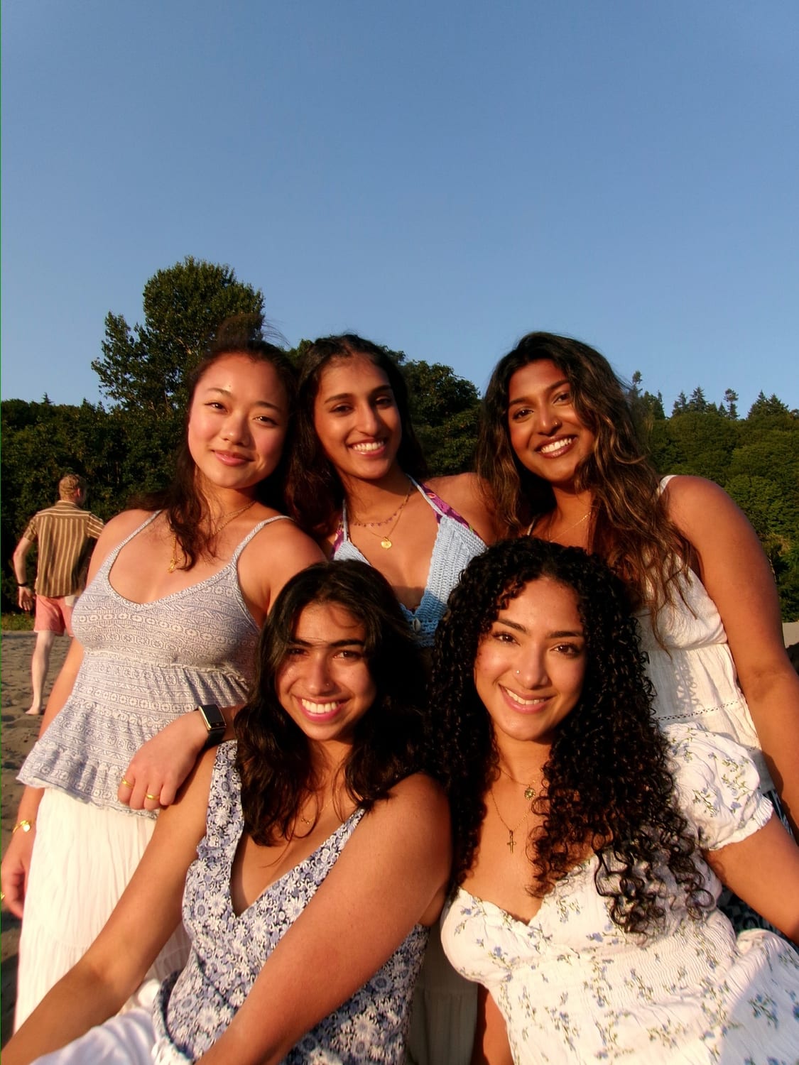 Ava with friends on the beach at golden hour