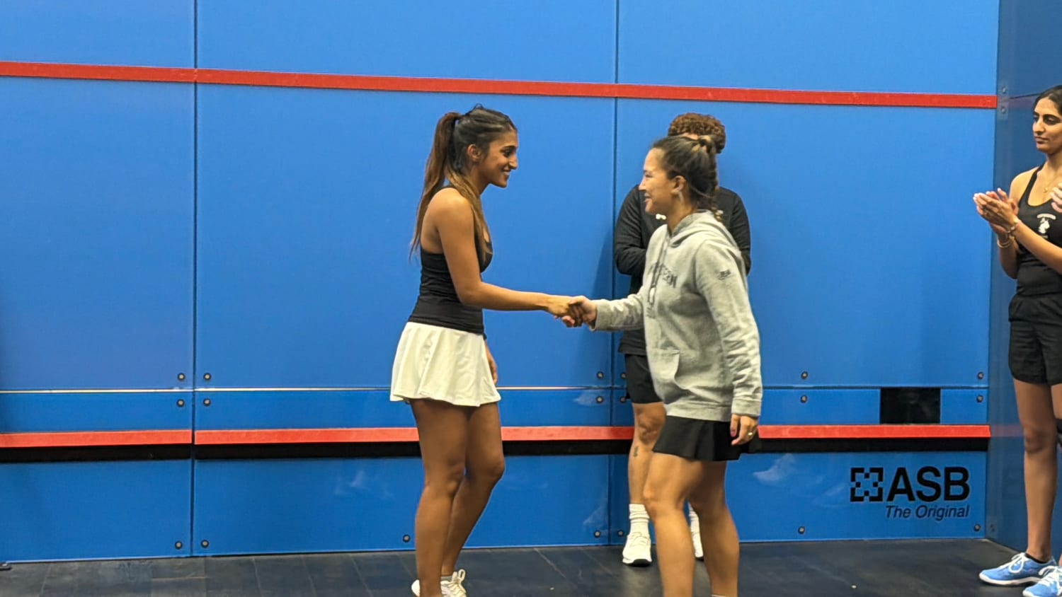 Ava shaking hands after a squash match