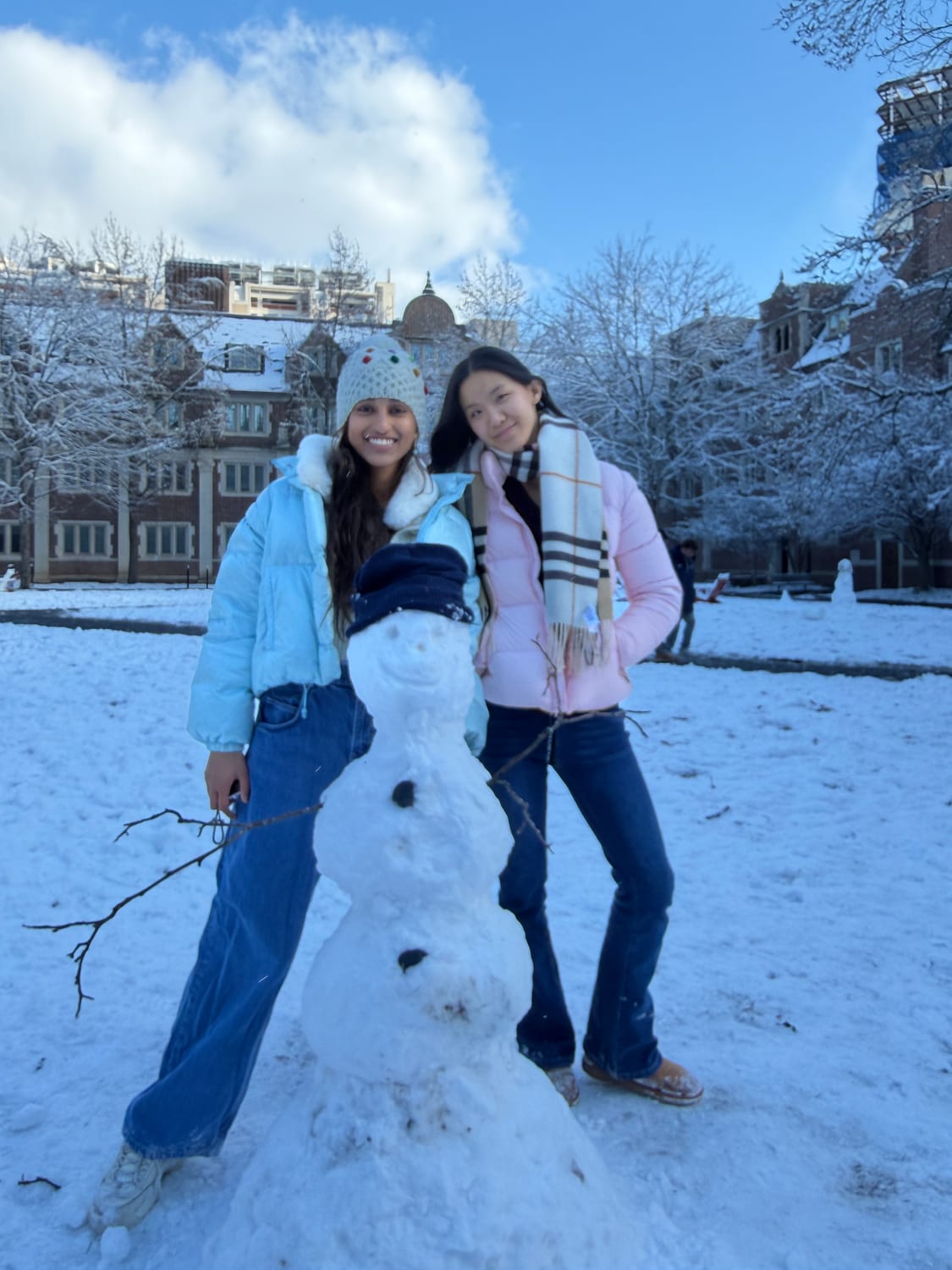 Ava and a friend with a snowman on the Penn quad