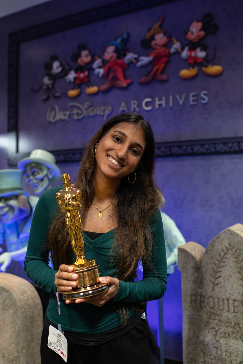 Ava holding an Oscar statuette at the Walt Disney Archives during the Chick-fil-A scholars trip