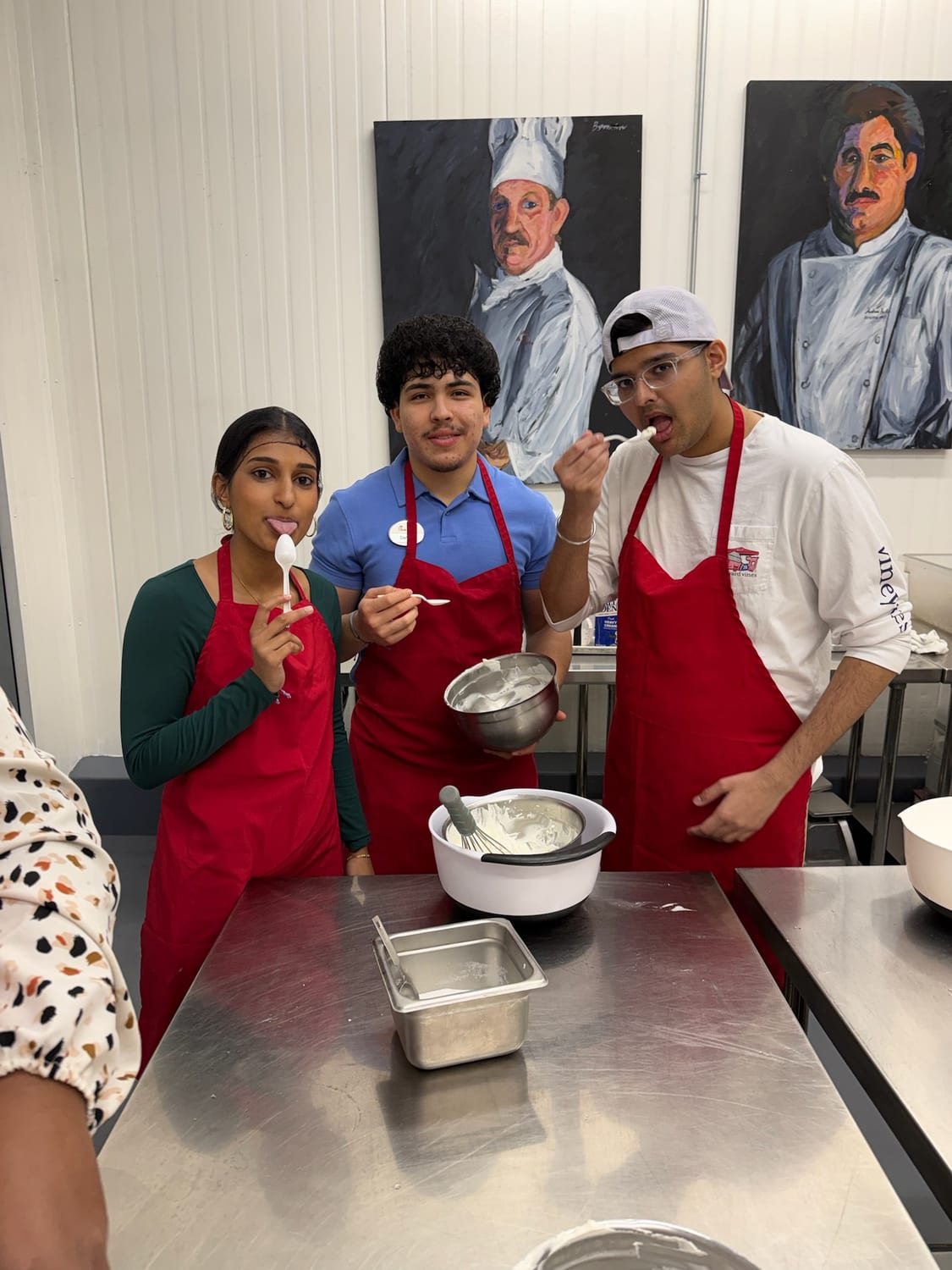 Ava tasting fresh whipped cream in a pastry class