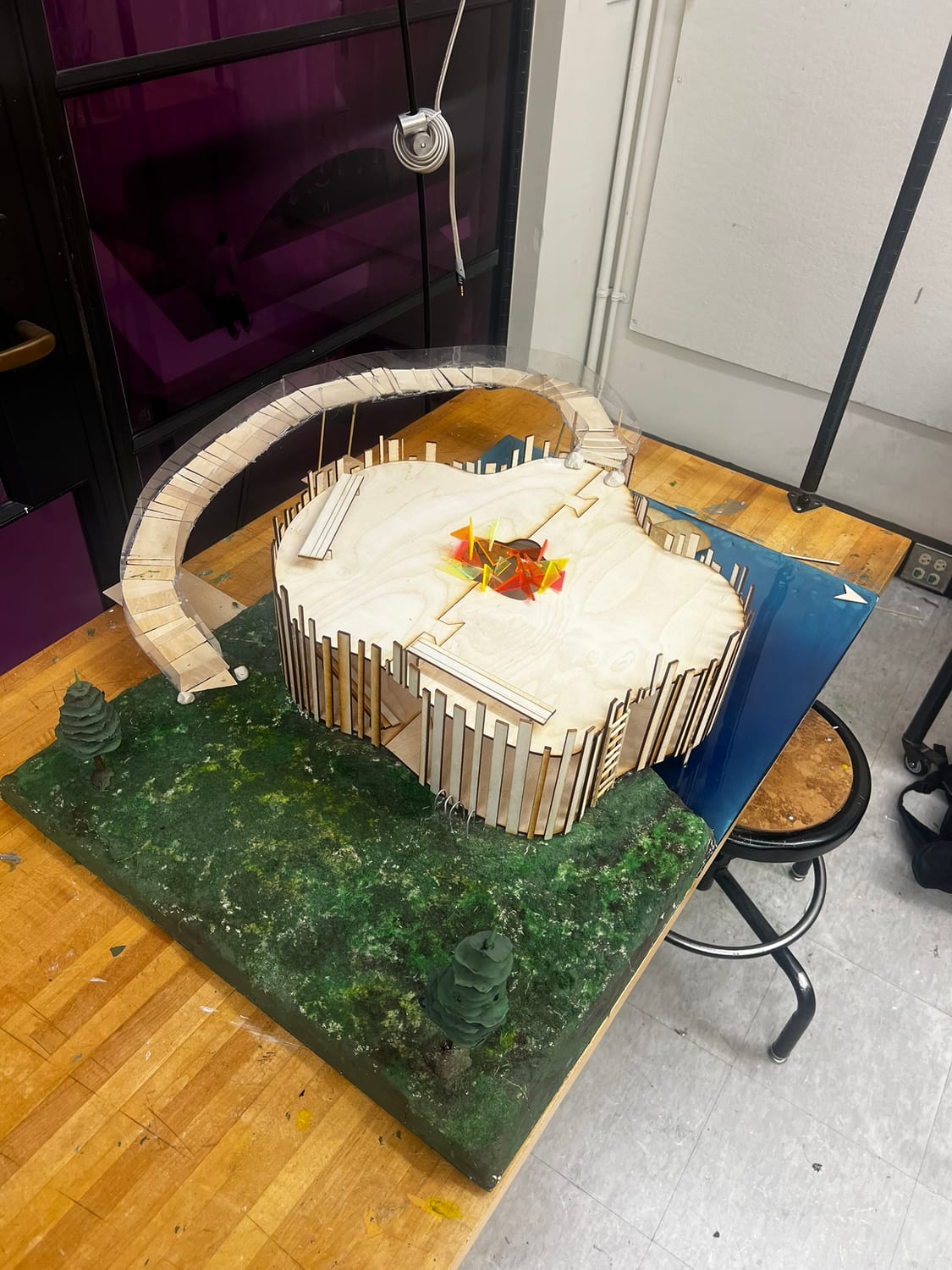 Overhead three-quarter view of the completed model showing the cloud-shaped plan and the elevated walkway looping around it.
