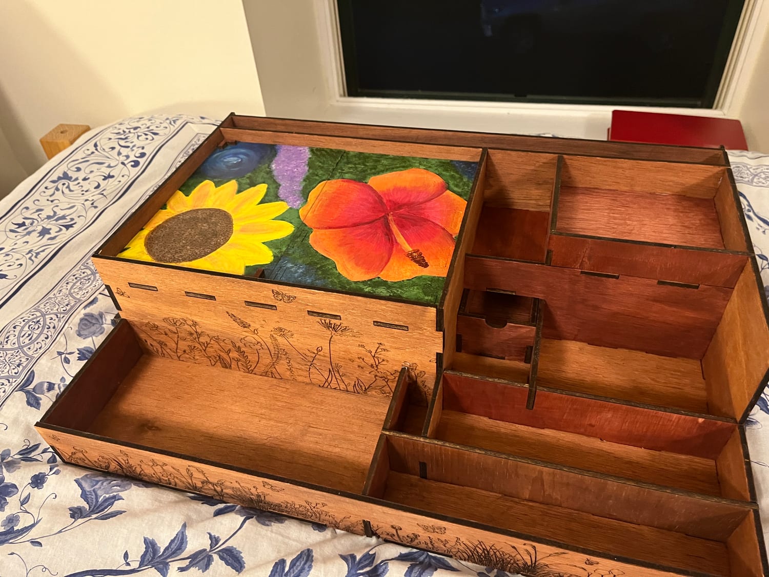 Both hand-painted panels laid over the case as its lid, with the full compartment structure exposed alongside.