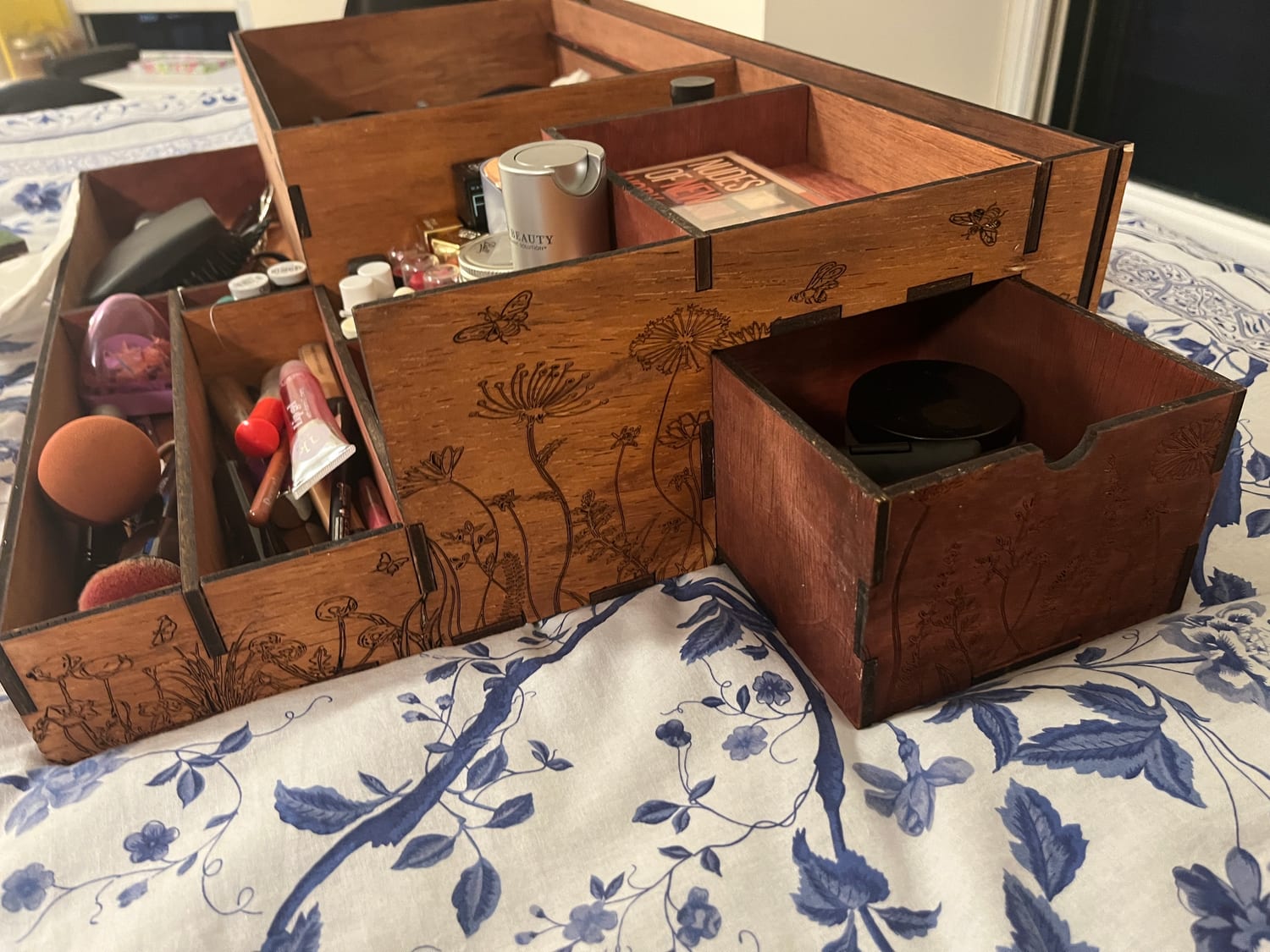 The same secret drawer pulled fully out, nested between the stepped compartments.