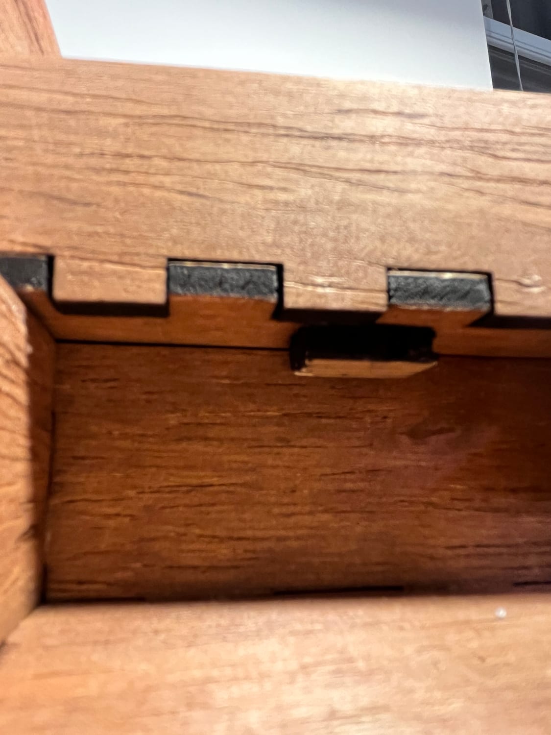 The drawer's internal stopper: a small tab that catches on the frame so the drawer slides out but can't fall free.