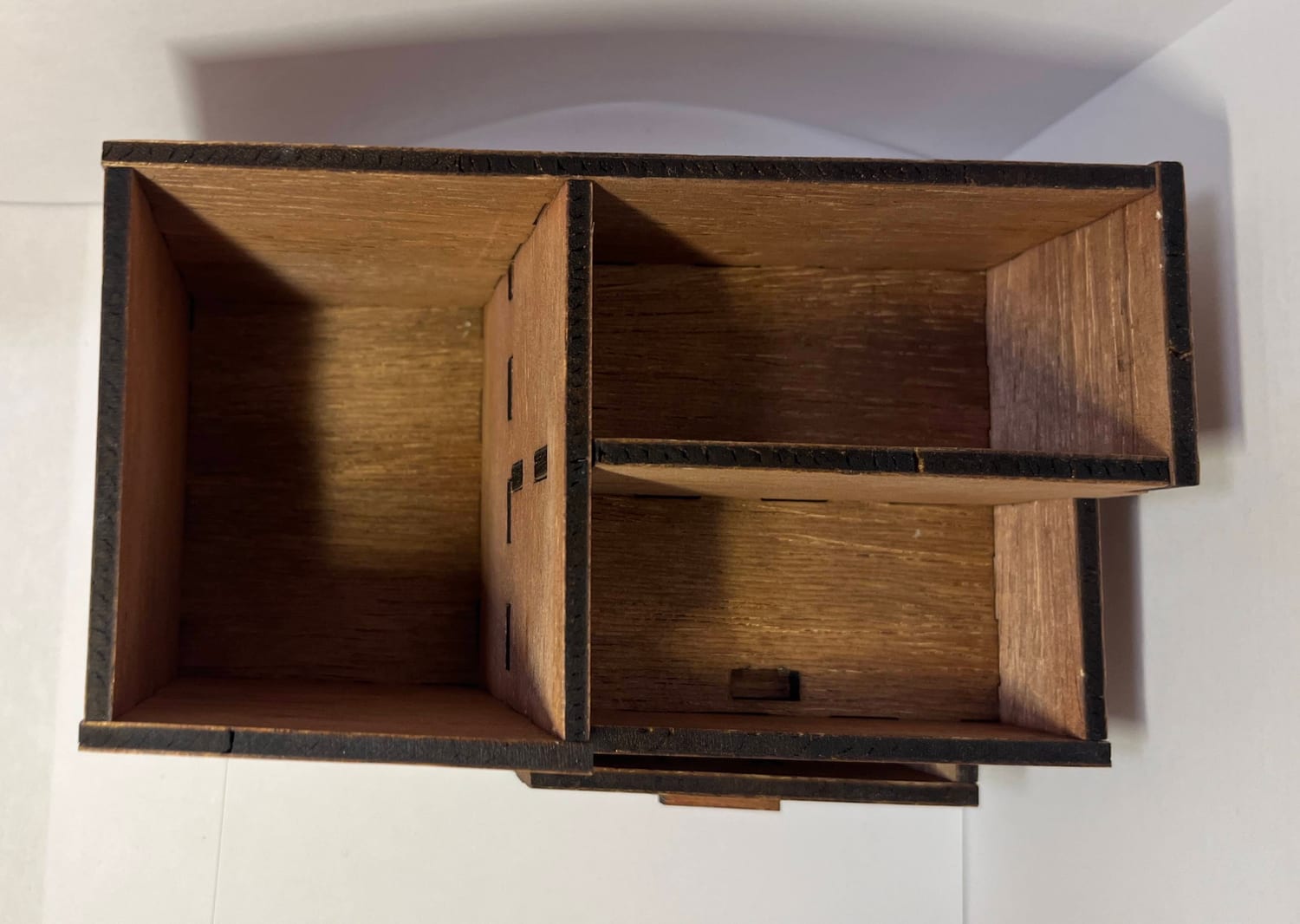 Top-down and empty, showing the two compartments, the open bay, and the drawer slot.