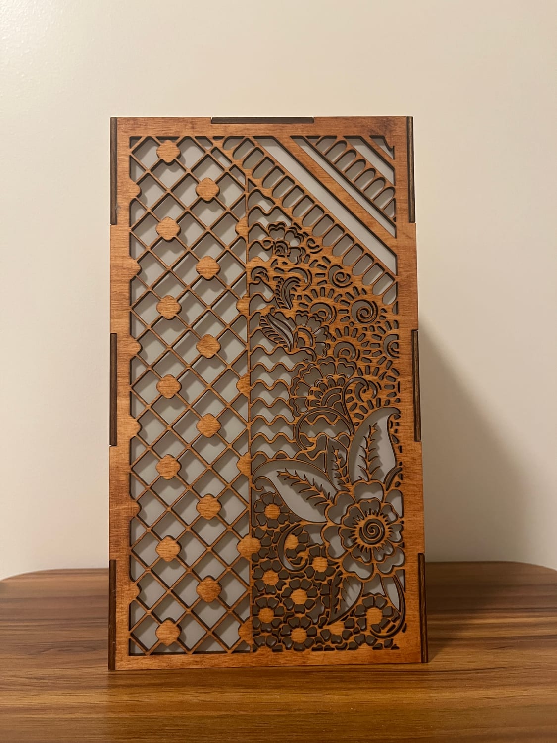 Another face: a diamond lattice with dotted flowers on one half, a full henna floral spray on the other.