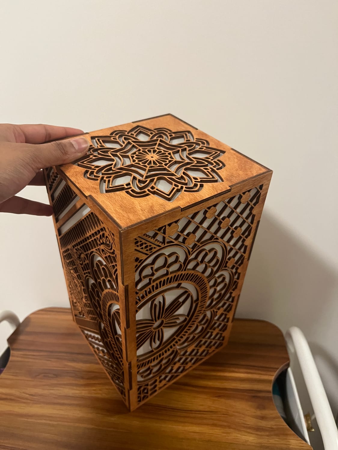 Lifting the lid off the top of the lantern; its centre is a separate mandala rosette.