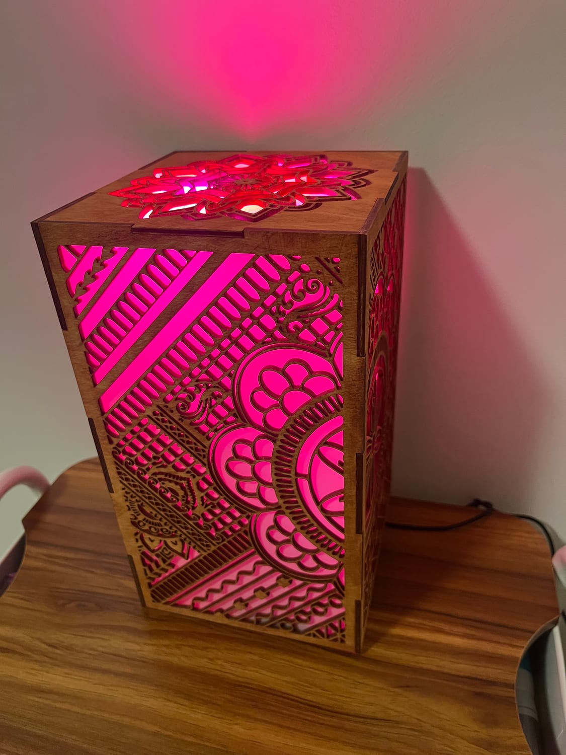 The same lantern with the bulb set to magenta — the whole mehndi pattern shifts colour.
