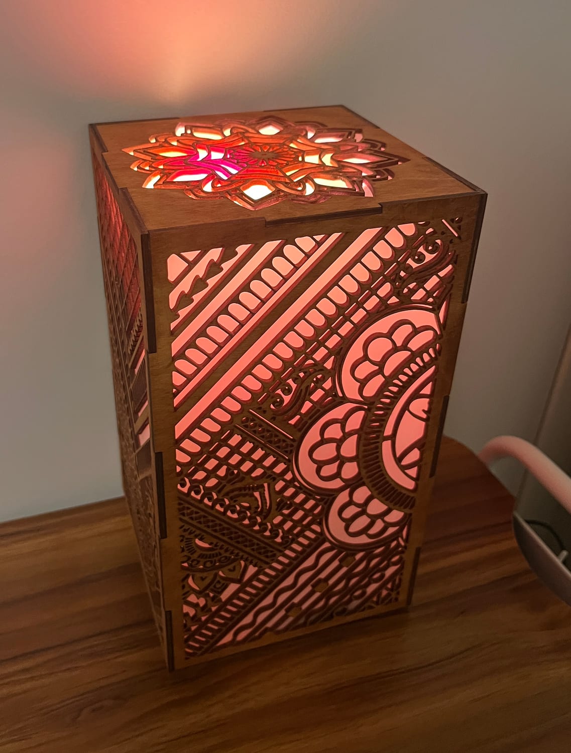 Another warm-lit angle, the henna pattern reading as light and shadow across two faces.