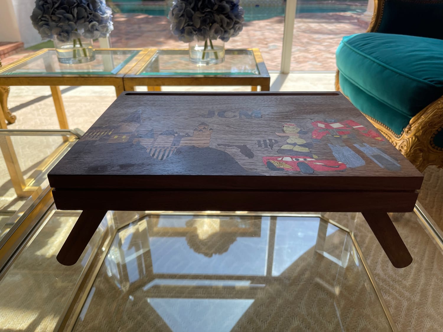 The desk standing on its unfolded legs, side on, showing how shallow it packs down.