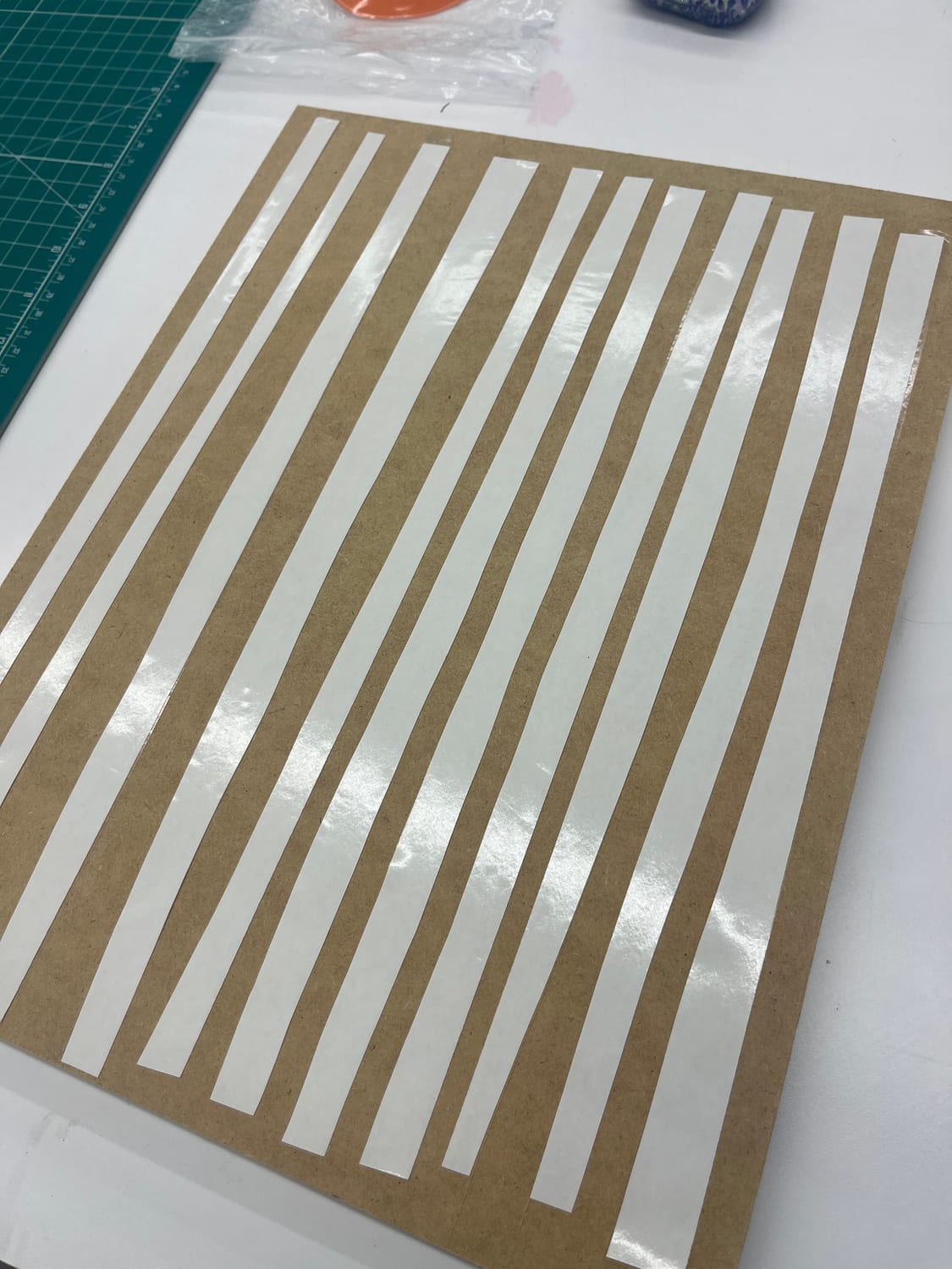 Veneer tape laid across a sheet of veneer to hold the grain together before cutting.