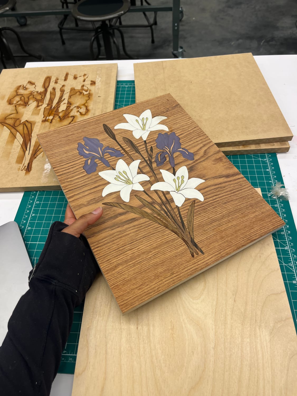 The finished panel next to the scorched laser template offcut — the negative the pieces were cut from.