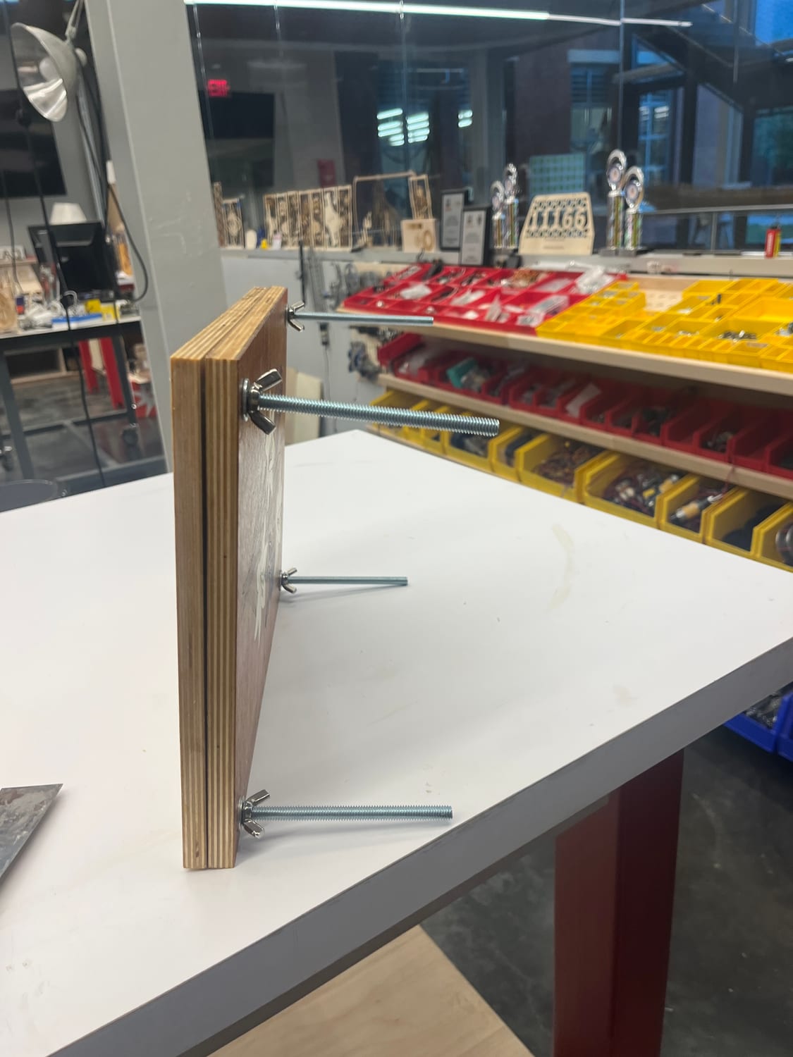 Side on: the two thick plywood boards and four threaded rods that make it an actual press.