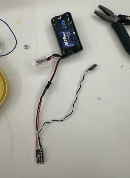 The 7.2 V NiMH battery pack and the brushless ESC that drive the car.
